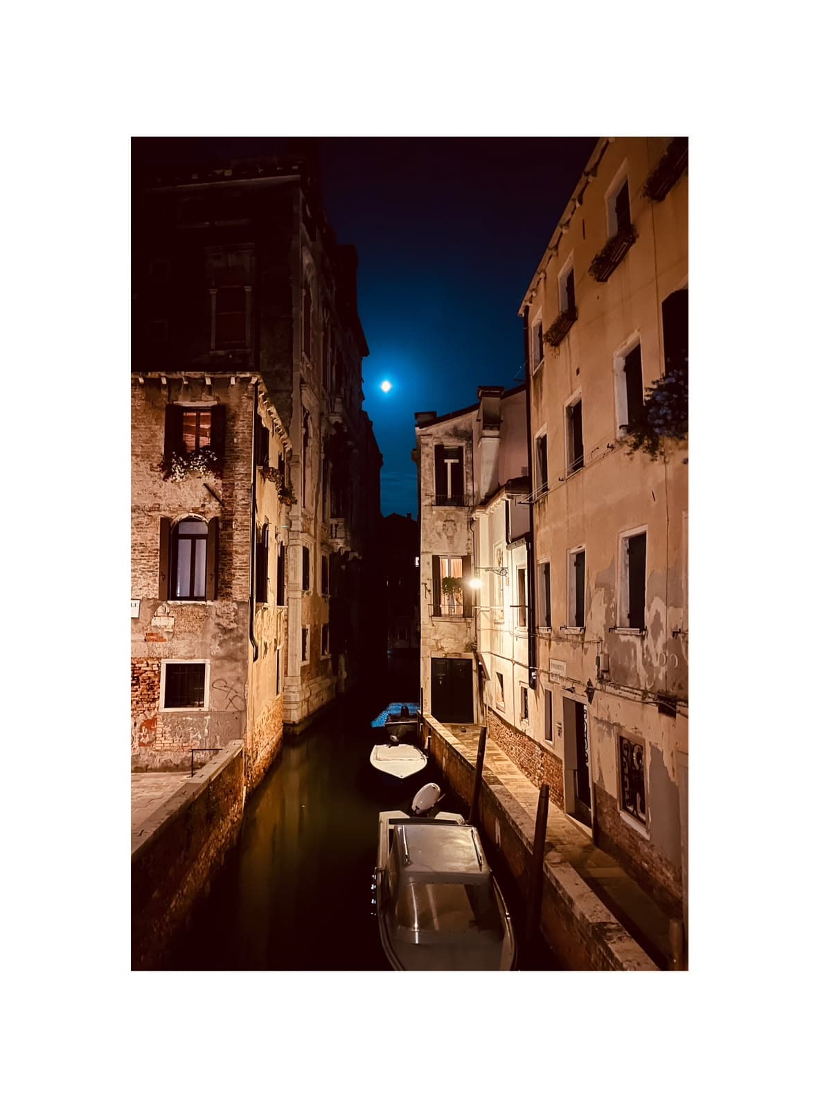 Night canal fine art photograph with moon reflections in Italy by Andrea Polmüller